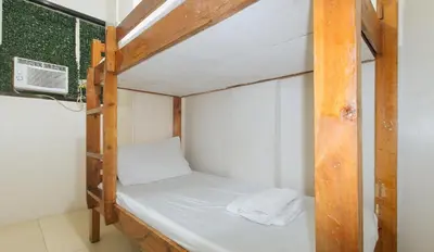 a couple of bunk beds in a room at Nearest Hostel Pasay City by RedDoorz in Manila