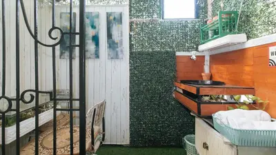 a bathroom with a fence and a sink in it at Nearest Hostel Pasay City by RedDoorz in Manila