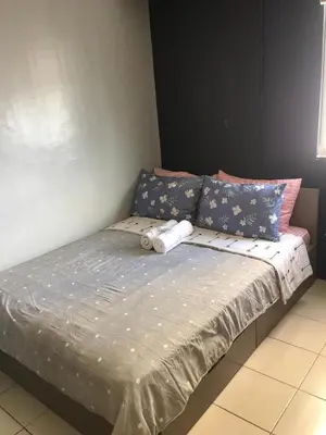 a bed with two pillows on top of it at Ronz Deca Hills in Manila