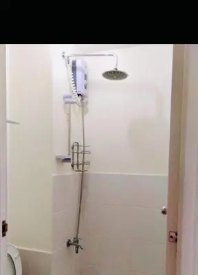 a bathroom with a shower with a hair dryer at Ronz Deca Hills in Manila
