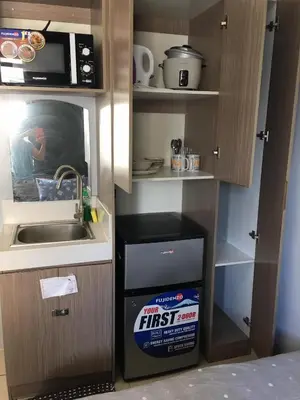 a kitchen with a sink and a box of first floor cardboard at Ronz Deca Hills in Manila