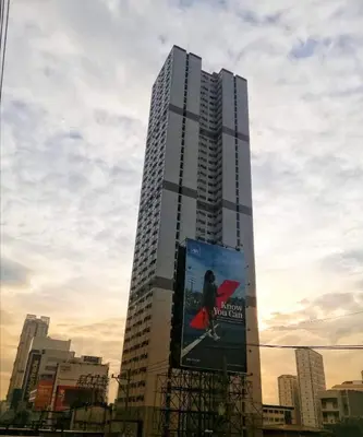 a tall building with an advertisement on the side of it at Ronz Deca Hills in Manila