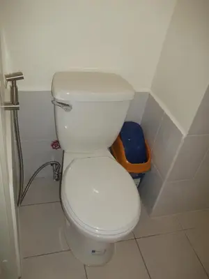 a bathroom with a white toilet in a stall at Ronz Deca Hills in Manila