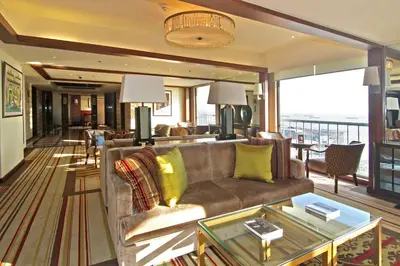 a living room with a couch and a table at The Manila Hotel in Manila