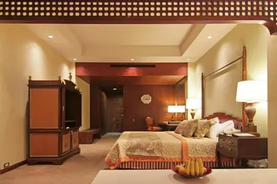 a hotel room with a bed and a television at The Manila Hotel in Manila