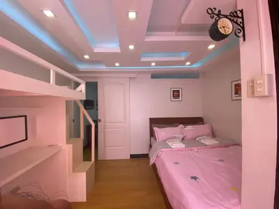 a bedroom with a bed and a blue ceiling at MidKnight Sky Unit for Rent in Anabu Primero