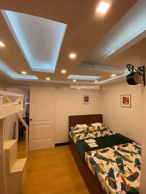a bedroom with a bed and a skylight at MidKnight Sky Unit for Rent in Anabu Primero