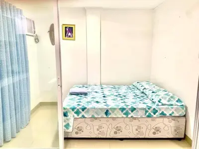 a bedroom with a bed in a room at Cozy Central - Near arca south signal taguig in Manila