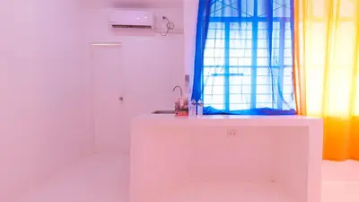 a white room with a sink and a window at RedDoorz @ Jolly Orange Paranaque in Manila