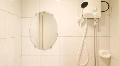 a bathroom with a mirror and a shower at RedDoorz @ Jolly Orange Paranaque in Manila