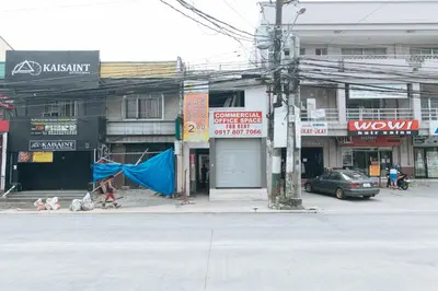 a city street with a building on the corner at RedDoorz @ Jolly Orange Paranaque in Manila