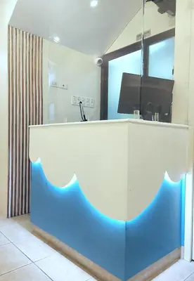 a white and blue reception desk in a room at airobedz MANILA - A Value Hotel in Manila