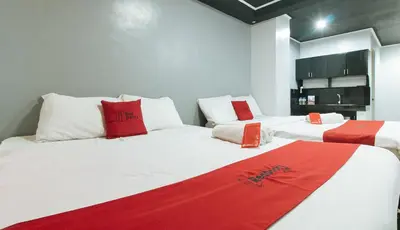 two beds with red and white pillows in a room at RedDoorz @ Good 101 Quiricada Manila in Manila