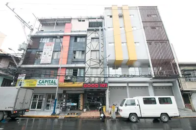 a white van parked in front of a building at RedDoorz @ Good 101 Quiricada Manila in Manila