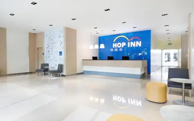 an office lobby with a hore inn sign on the wall at Hop Inn Ortigas Center Manila in Manila