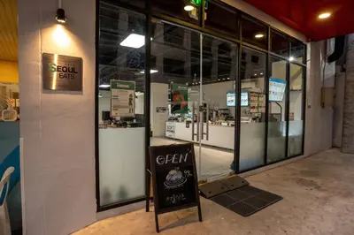 a store front with a sign in front of a store at Hop Inn Ortigas Center Manila in Manila