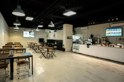 a dining room with tables and chairs and a counter at Hop Inn Ortigas Center Manila in Manila