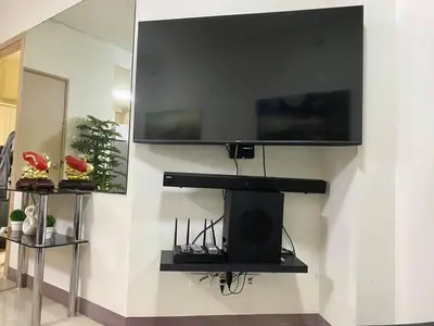 a wall with a flat screen tv on a wall at Field Residences in Manila