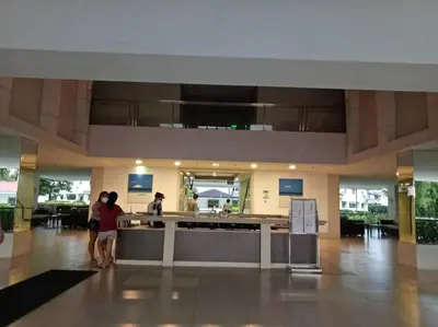 two people standing in the lobby of a building at Field Residences in Manila