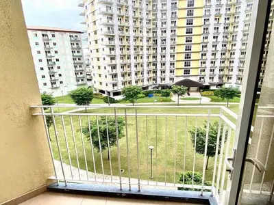 a balcony with a view of a large building at Field Residences in Manila