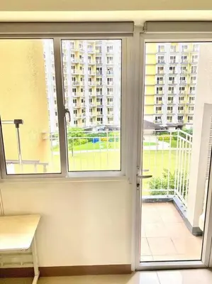 an open window with a view of a building at Field Residences in Manila