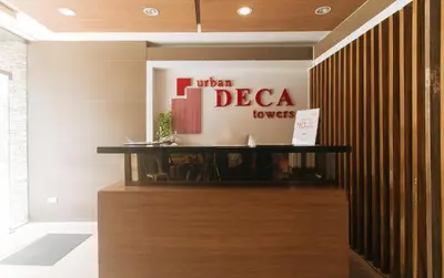 a sign for a hotel decca towels in a lobby at Eimys Place at Urban Deca Mandaluyong by RedDoorz in Manila