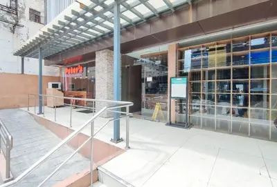 a store front of a building with revolving doors at Eimys Place at Urban Deca Mandaluyong by RedDoorz in Manila