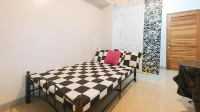 a bedroom with a black and white checkered bed at Budget Backpackers Transient House near NAIA by RedDoorz in Manila