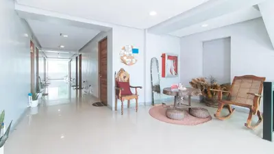 a hallway with chairs and a table in a room at Budget Backpackers Transient House near NAIA by RedDoorz in Manila