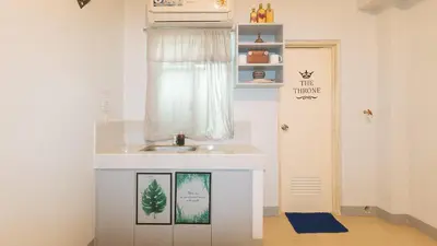 a small bathroom with a sink and a window at Budget Backpackers Transient House near NAIA by RedDoorz in Manila