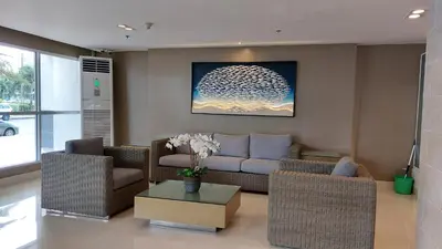a living room with a couch and a table at MSH property Sea Residences MOA Pasay City by Queennie in Manila
