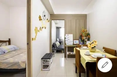 a room with a bed and a table and a bedroom at Lovely Condo 2-BR w/balcony in SM-Sucat, Paranaque in Manila