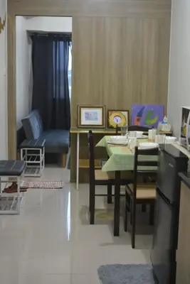 a dining room with a table and a couch at Lovely Condo 2-BR w/balcony in SM-Sucat, Paranaque in Manila