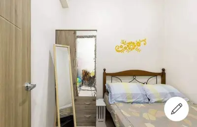 a bedroom with a bed next to a mirror at Lovely Condo 2-BR w/balcony in SM-Sucat, Paranaque in Manila