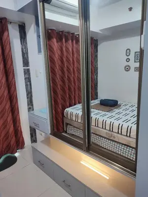 a mirror reflection of a bed in a room at Sea Residences MOA Complex - Ruffa's Condotel in Manila