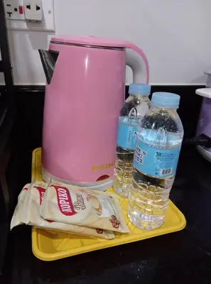 a pink blender and two bottles of water on a tray at Paranaque SM-Sucat Field Res. Bldg 5, 2/F, 2BR with Balcony in Manila