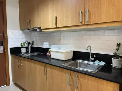 a kitchen with a sink and a counter top at MOA staycation Shell Residences Pasay city darpm in Manila