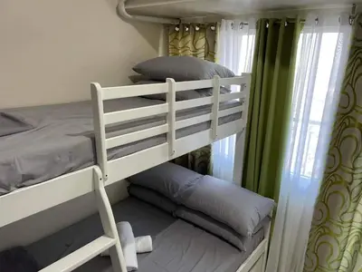 a couple of bunk beds in a room at Staycation Taft Ave DLSU Green Res by darpm in Manila