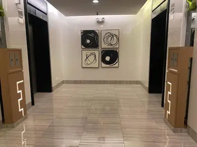 a hallway with black and white art on the wall at Staycation Taft Ave DLSU Green Res by darpm in Manila