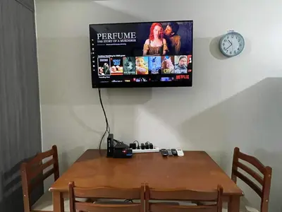 a television hanging on a wall above a table at Staycation Taft Ave DLSU Green Res by darpm in Manila