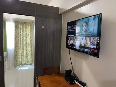 a television hanging on a wall in a room at Staycation Taft Ave DLSU Green Res by darpm in Manila