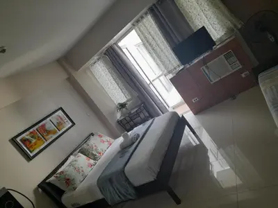 an overhead view of a bedroom with a bed and a window at One Palm Tree Villas-Kenzie Place Terminal 3 Airport in Manila
