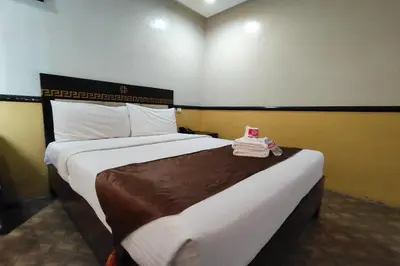 a hotel room with a large bed in a room at Manila Crown Palace Hotel in Manila