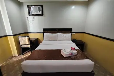 a bedroom with two beds in a room at Manila Crown Palace Hotel in Manila