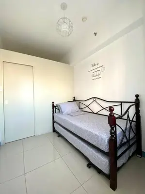 a bedroom with a bed in a room at A Cozy 2 Bedroom Unit with a Parking at Tower 2 South Residences SM Southmall in Manila