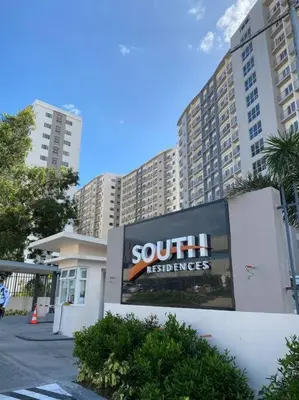 a large sign in front of a large building at A Cozy 2 Bedroom Unit with a Parking at Tower 2 South Residences SM Southmall in Manila