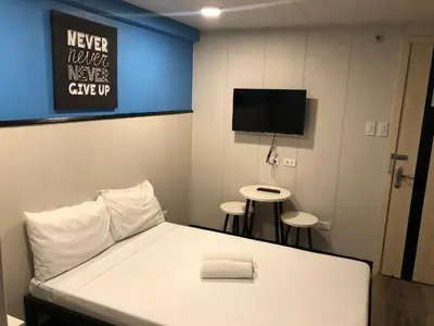 a hospital room with a bed and a flat screen tv at Maine City Residences Leveriza in Manila