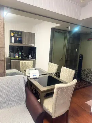 a room with a table and chairs and a bed at FRD Condo Unit Tower A SoleMare Parksuites in Manila