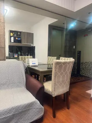 a room with a table and chairs and a bed at FRD Condo Unit Tower A SoleMare Parksuites in Manila