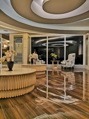 a lobby with chairs and a table and a ceiling at SHORE RESIDENCE d6, shortwalk Mall of Asia near Airport in Manila